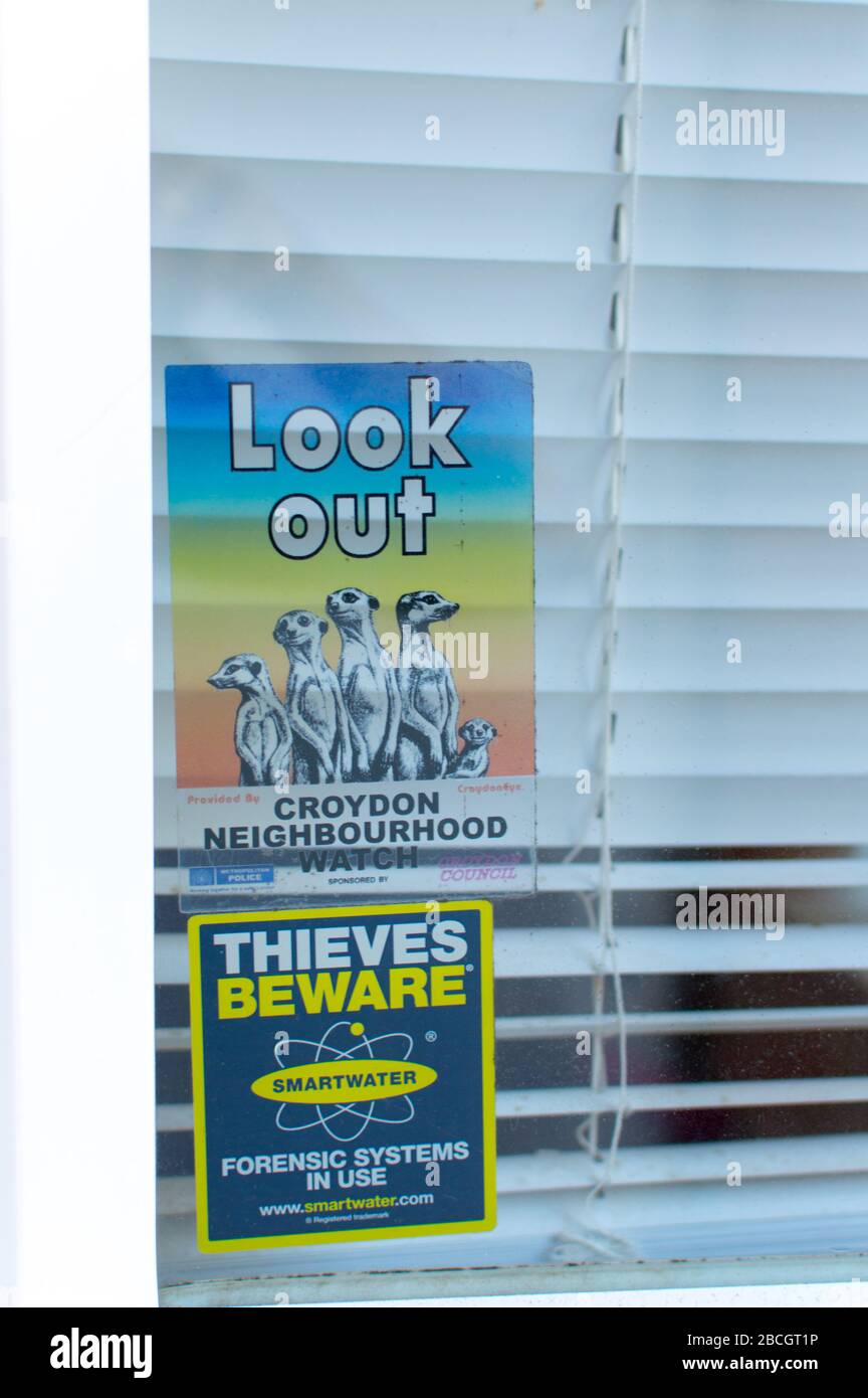 Neighborhood watch stickers on doors and windows Stock Photo