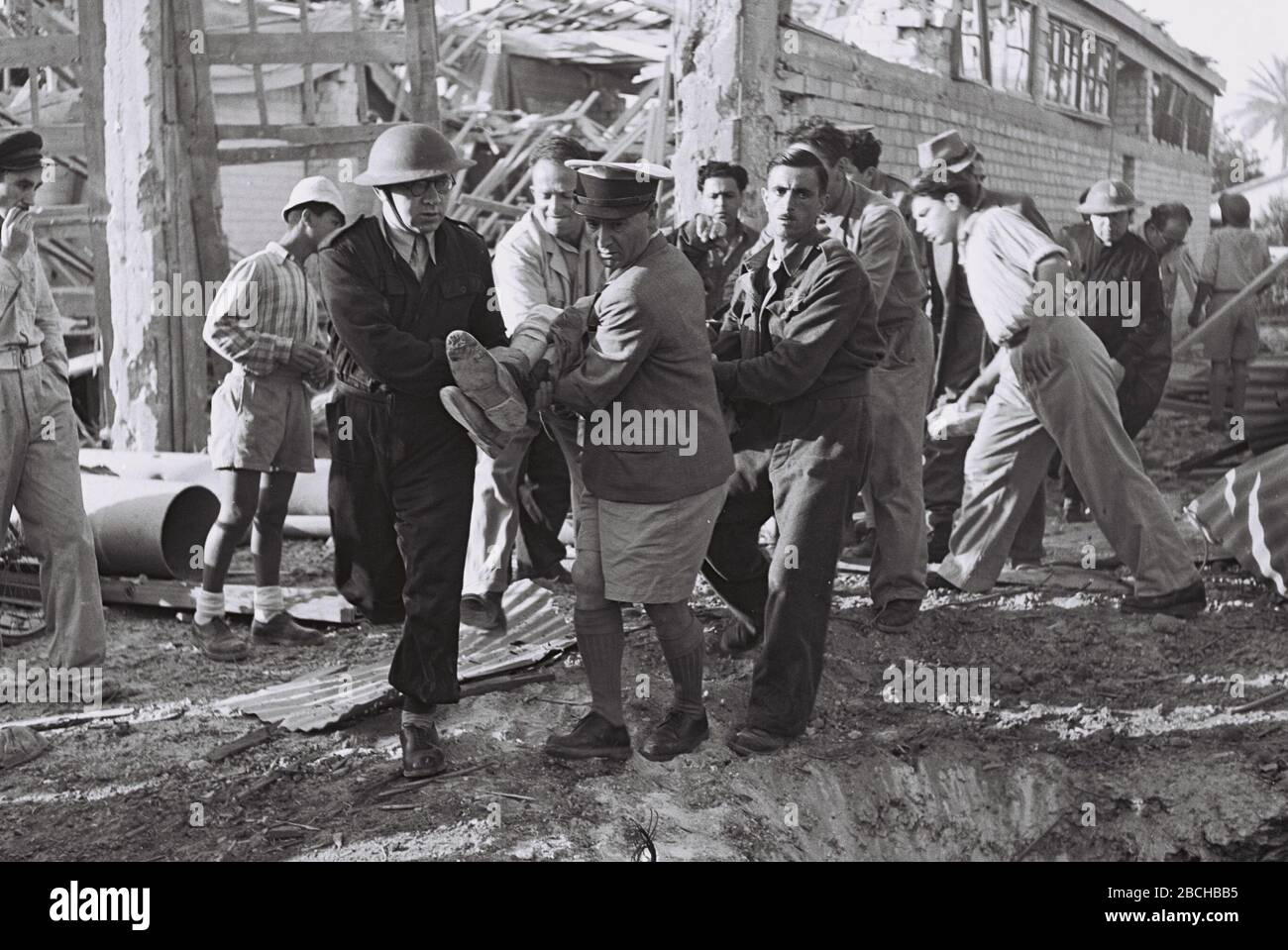 English Hagana Volunteers Evacuating A Man Wounded In Egypt S Bombardment Of Tel Aviv During The War For Independence E O U U O U I U E I E O U I U O E O I I I I U I E O U U