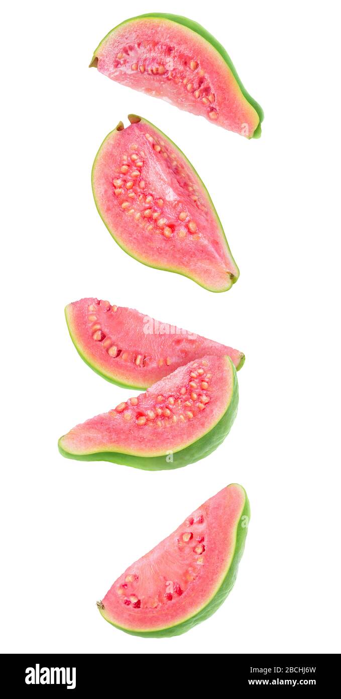 Guava fruit pieces in the air. Five slices of fresh guava with pink flesh falling over white background Stock Photo