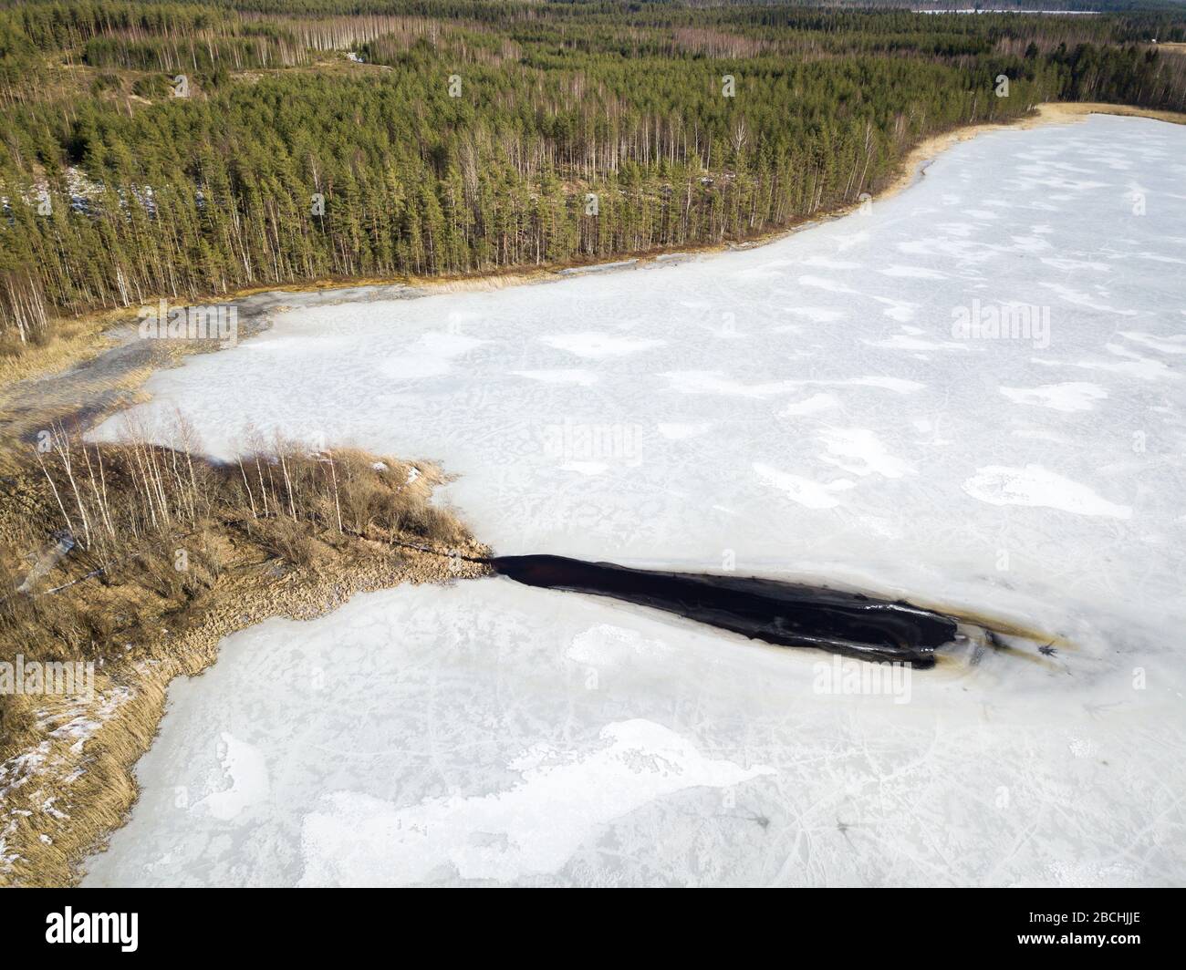 Melt ice at frozen lake near ditch mount Stock Photo Alamy