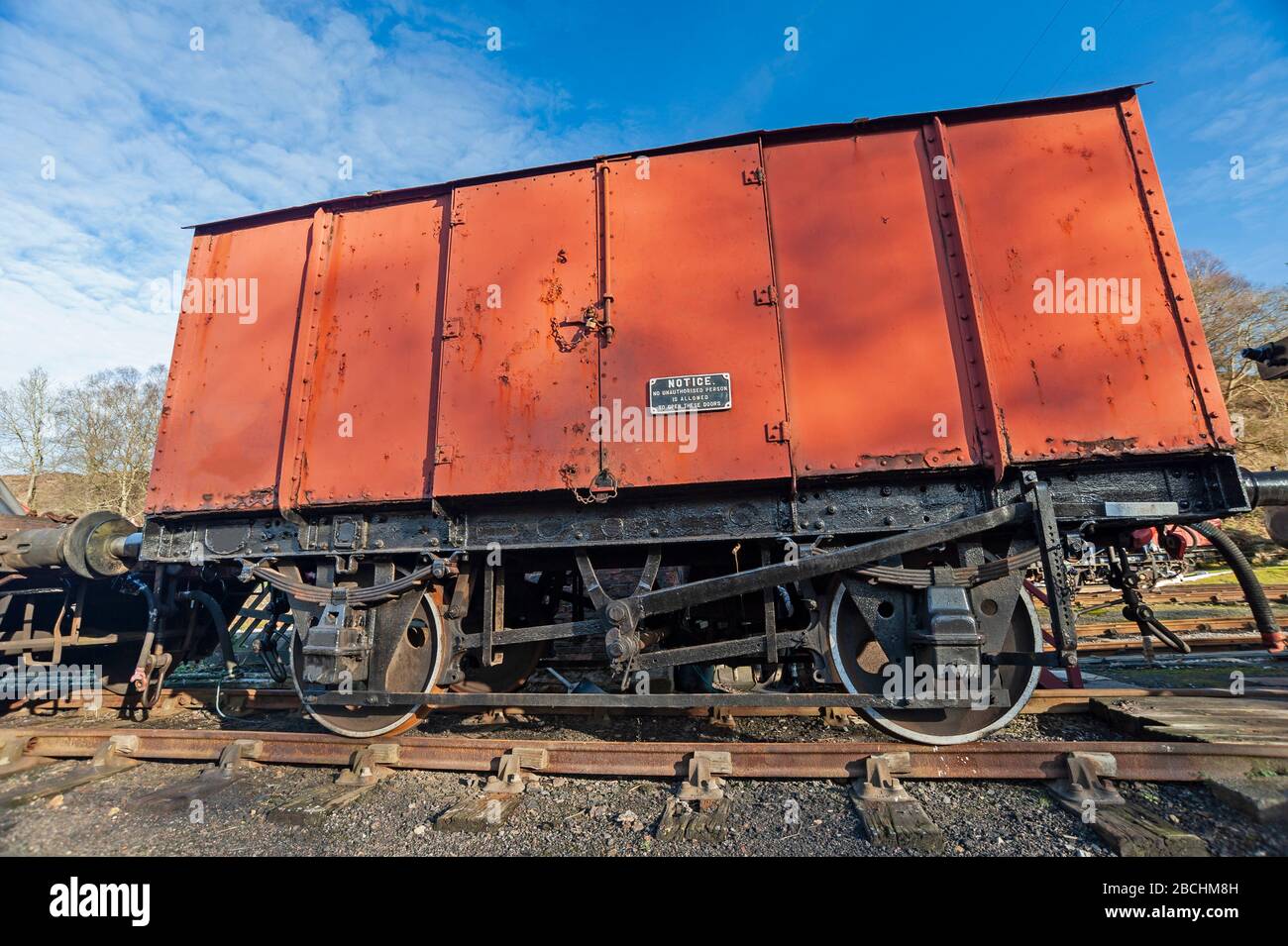 Old traditional railway rolling stock box car on a siding in rural countryside station Stock Photo