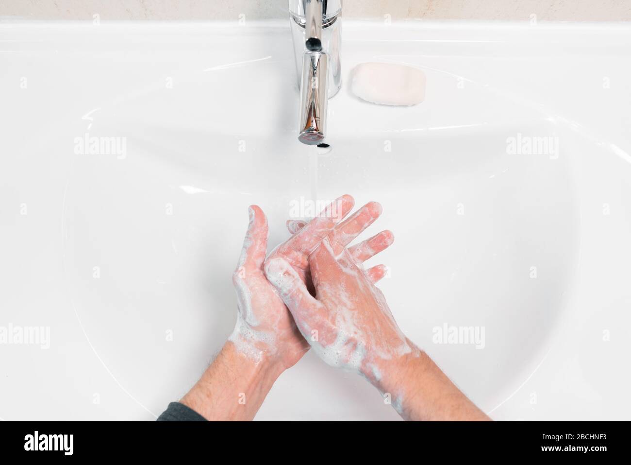 Washing hands rubbing with soap man for corona virus prevention, hygiene to stop spreading coronavirus. Stock Photo