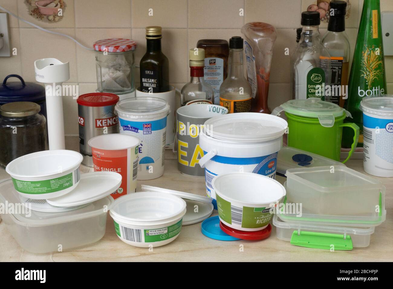 collection of plastic tubs on kitchen worktop Stock Photo Alamy