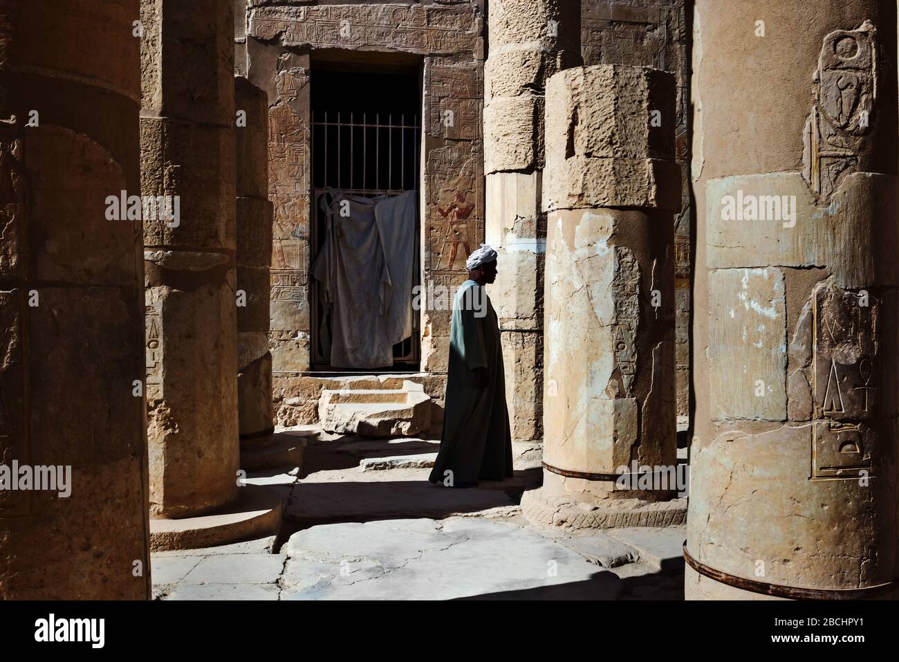 Luxor, Egypt Jan 25, 2015 Man walking by doors and columns in Queen Hatshepsut's Temple