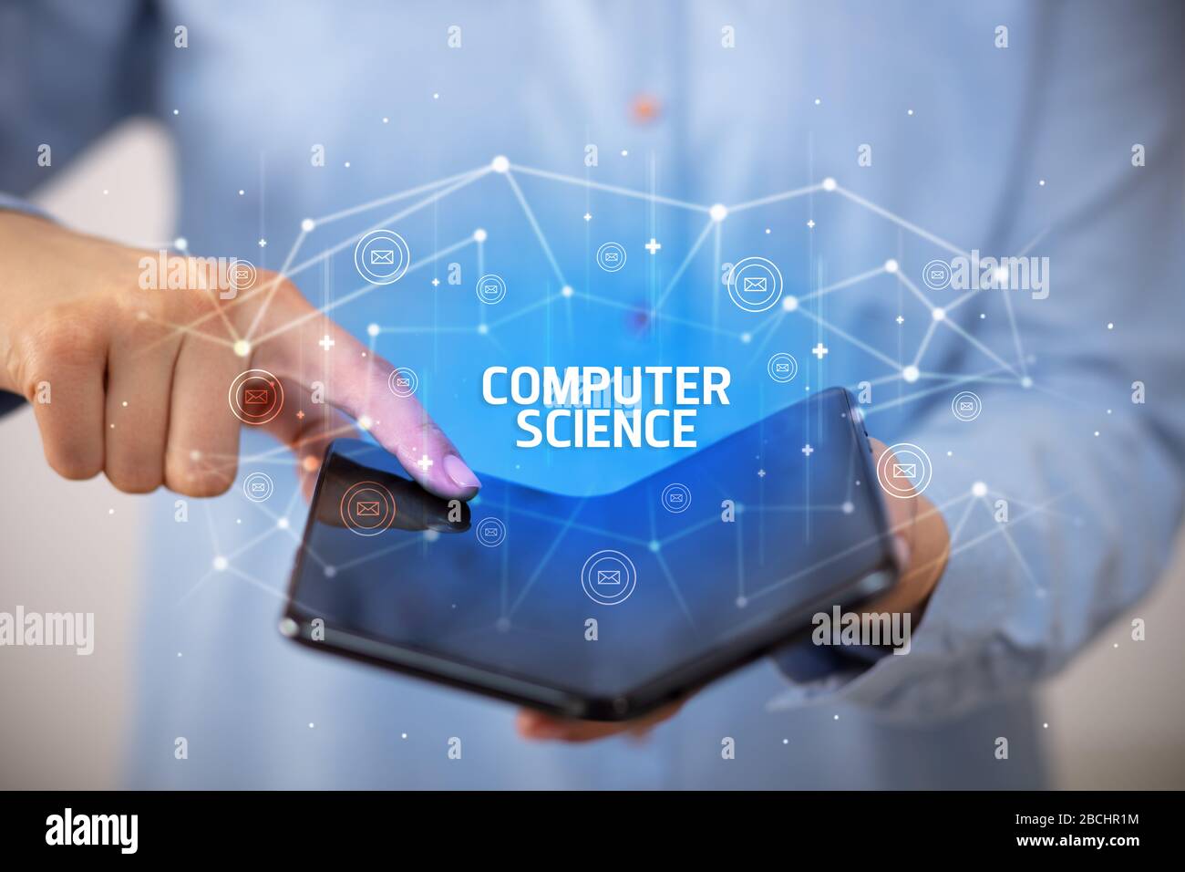 Businessman holding a foldable smartphone with COMPUTER SCIENCE inscription, new technology concept Stock Photo