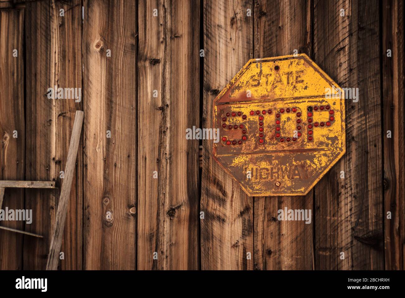 rusting stop sign on clapboard building. Nelson, Nevada, United States Stock Photo