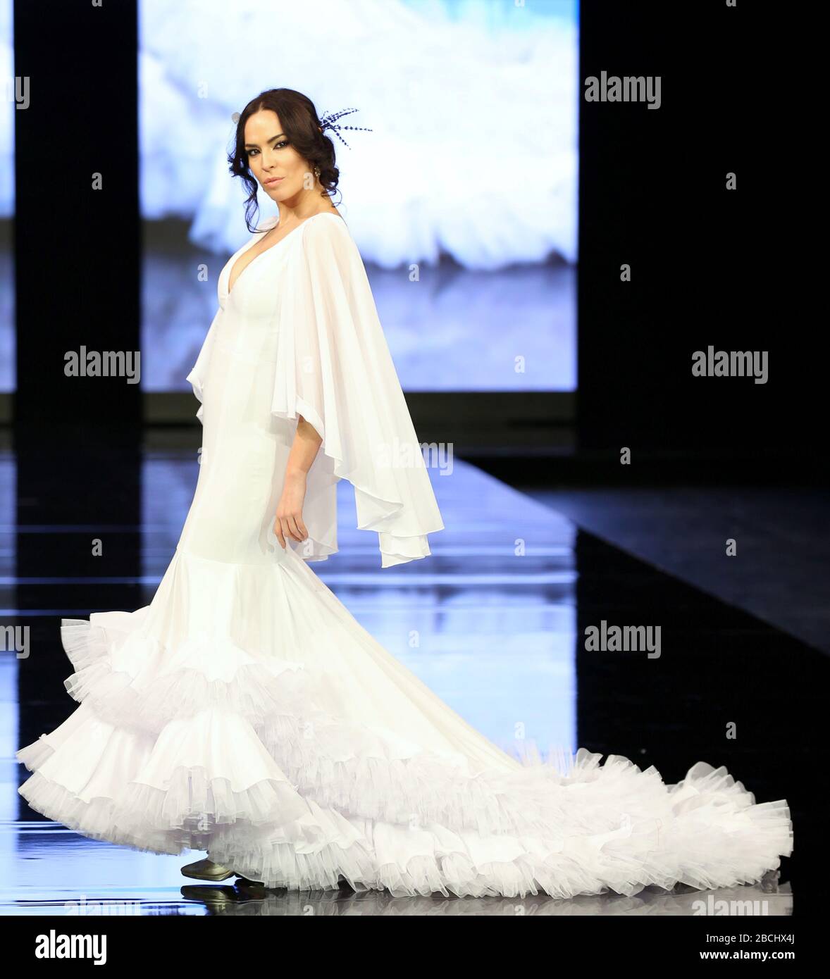SEVILLA, SPAIN - JAN 30: model Maria Ramos Rivas wearing a white dress from the Grasse collection of designer Fran Solis during the SIMOF 2020 (Photo credit: Mickael Chavet) Stock Photo