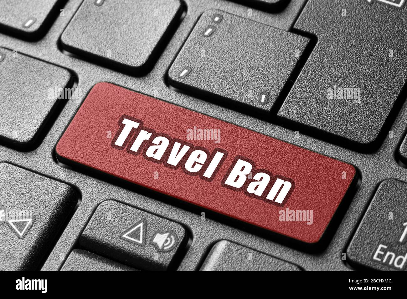 travel ban pc keyboard button pushing a single word Stock Photo - Alamy