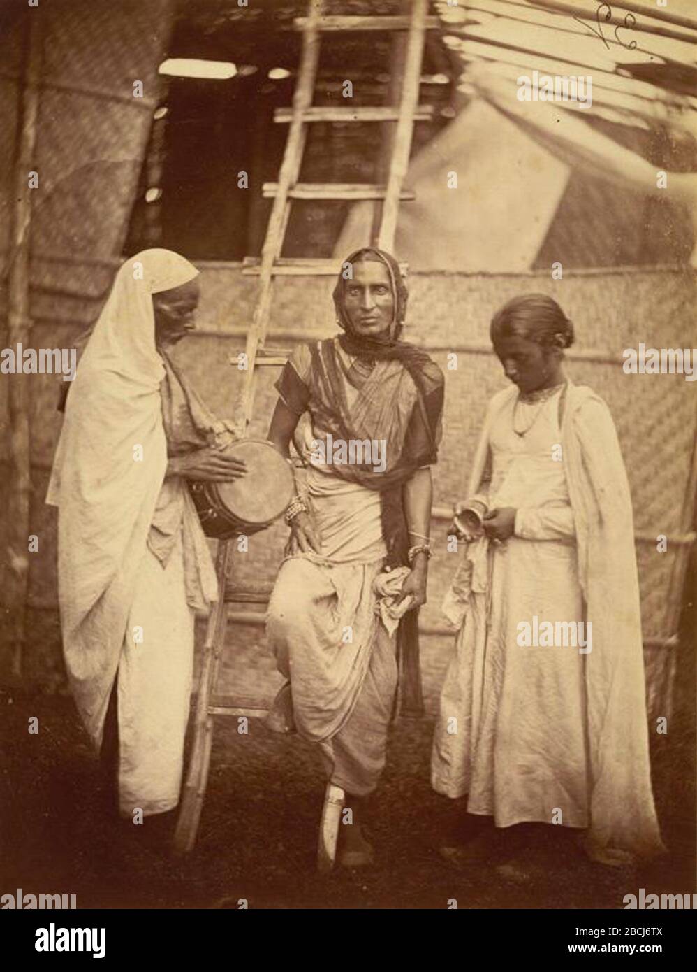 'English: A reputed hermaphrodite (Hijra) and companions – Eastern Bengal 1860′s. Hermaphrodite is the third gender, also known today in South Asia as ‘hijra’ they are often followers of the Hindu goddess Bahuchara Mata.; circa 1860 date QS:P,+1860-00-00T00:00:00Z/9,P1480,Q5727902; [1]; Unknown author; ' Stock Photo