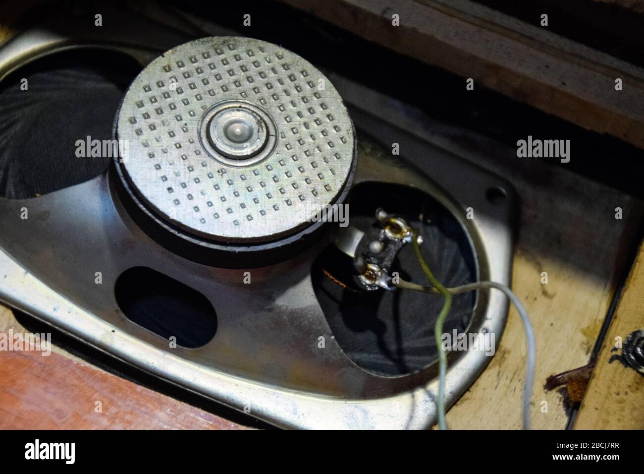 Soviet ferrite speaker 2GD-40, in a wooden casing of an acoustic column. Old Soviet acoustics. Repair of acoustic dynamics, ration soldering wire on t Stock Photo