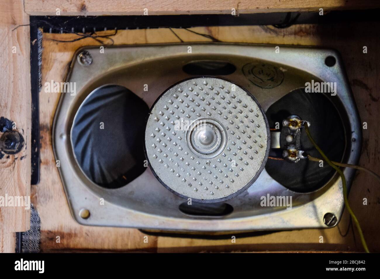 Soviet ferrite speaker 2GD-40, in a wooden casing of an acoustic column. Old Soviet acoustics. Repair of acoustic dynamics, ration soldering wire on t Stock Photo