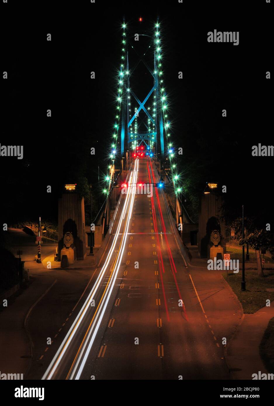 View From Stanley Park To The Lion's Gate Bridge In Vancouver At Night Stock Photo