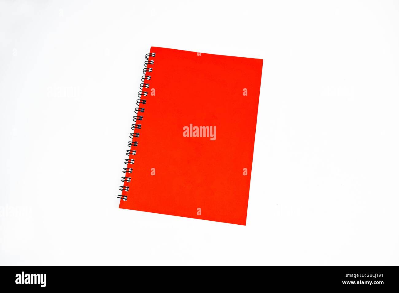 Red color covered single note paper diary isolated on an empty white background Stock Photo