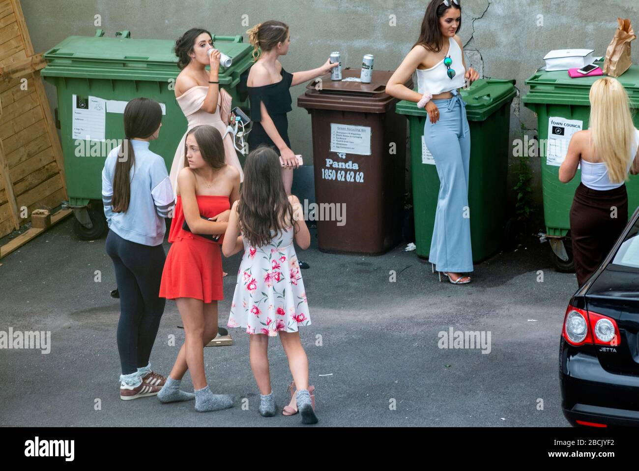 Prom Alcohol Young women and group of teenagers in smart prom dresses drinking ...