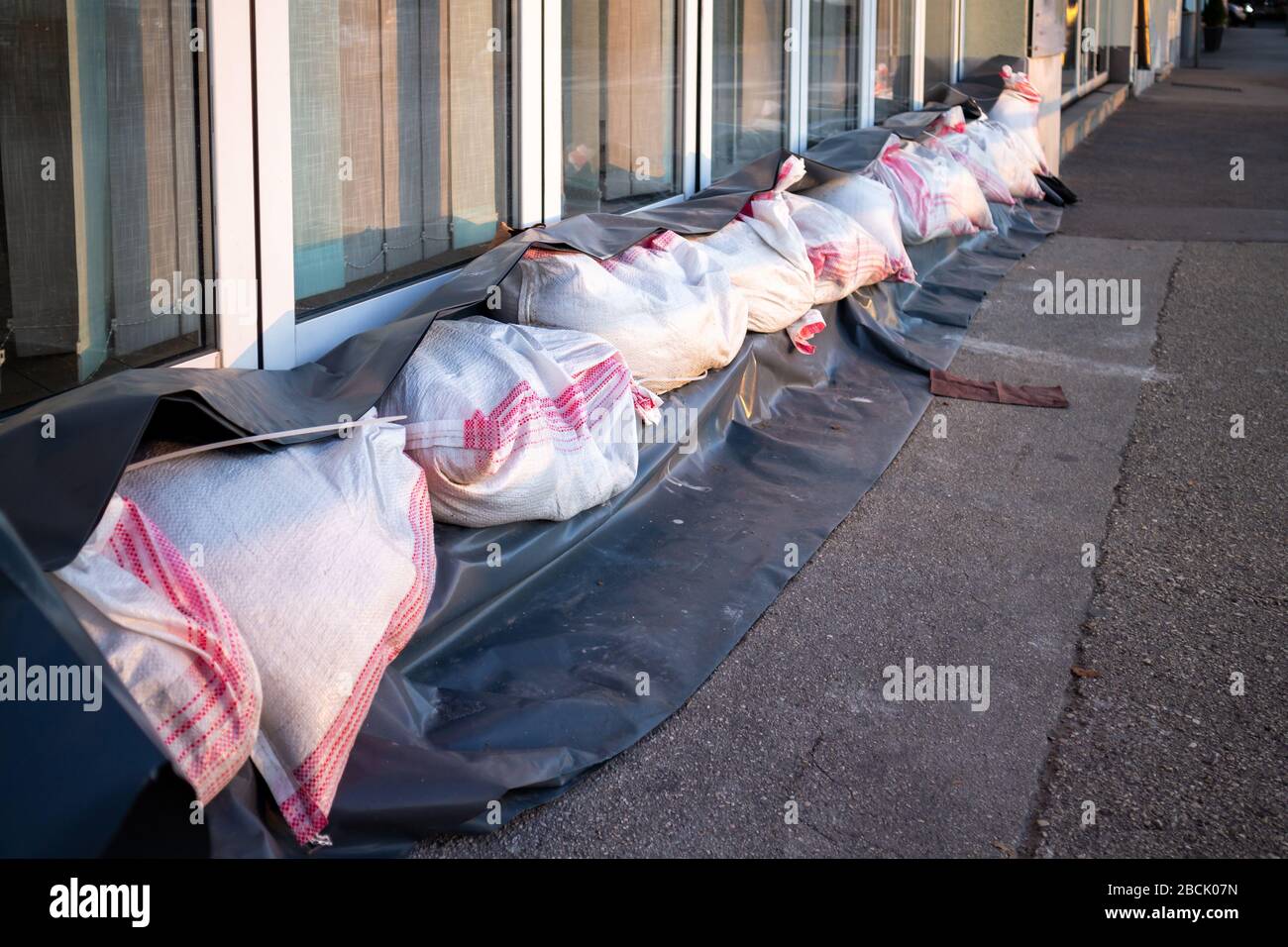 Sandbags stacked in front of doors to protect against flooding of river