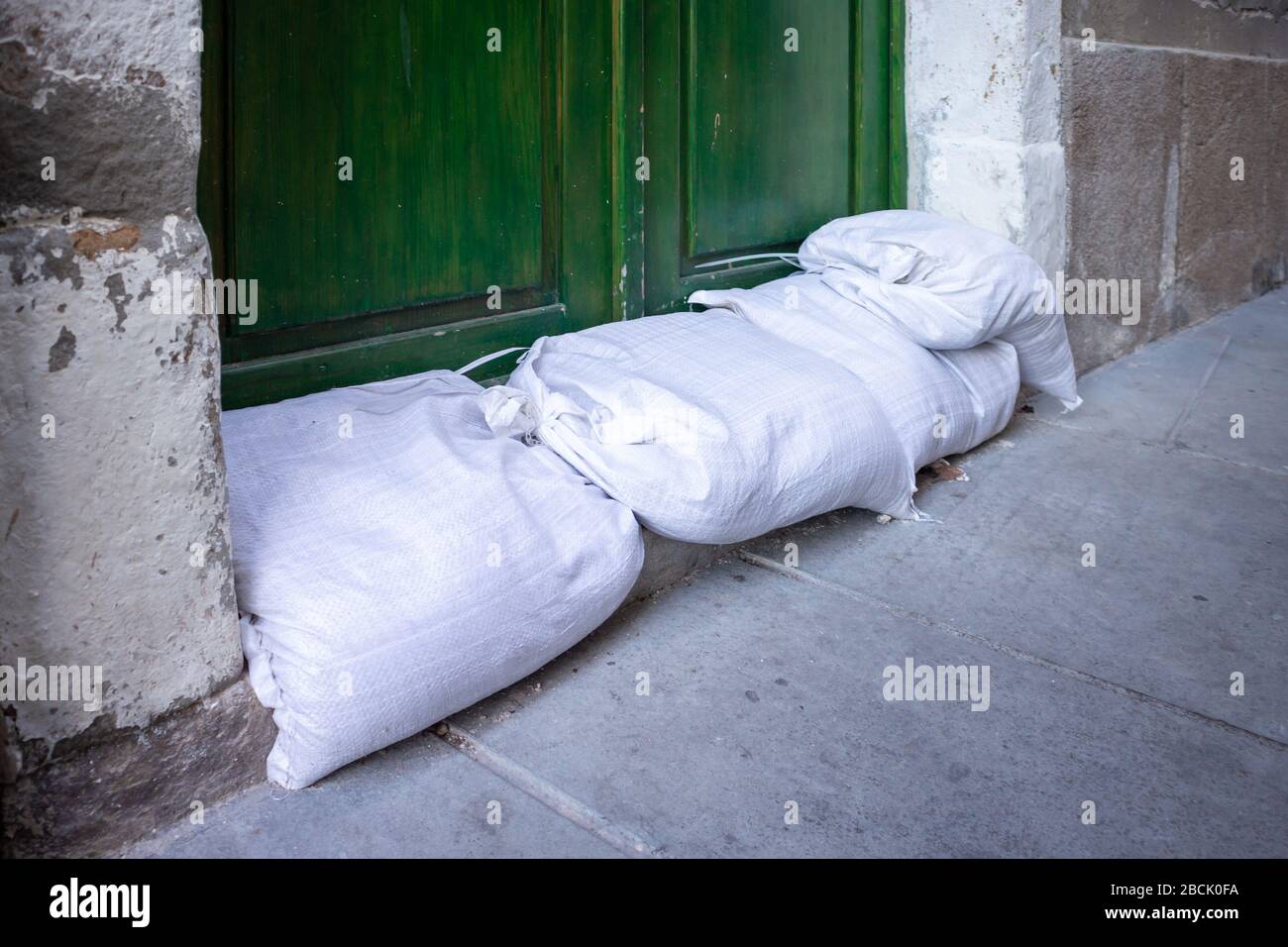 Sandbags stacked in front of doors to protect against flooding of river or sea Stock Photo Alamy