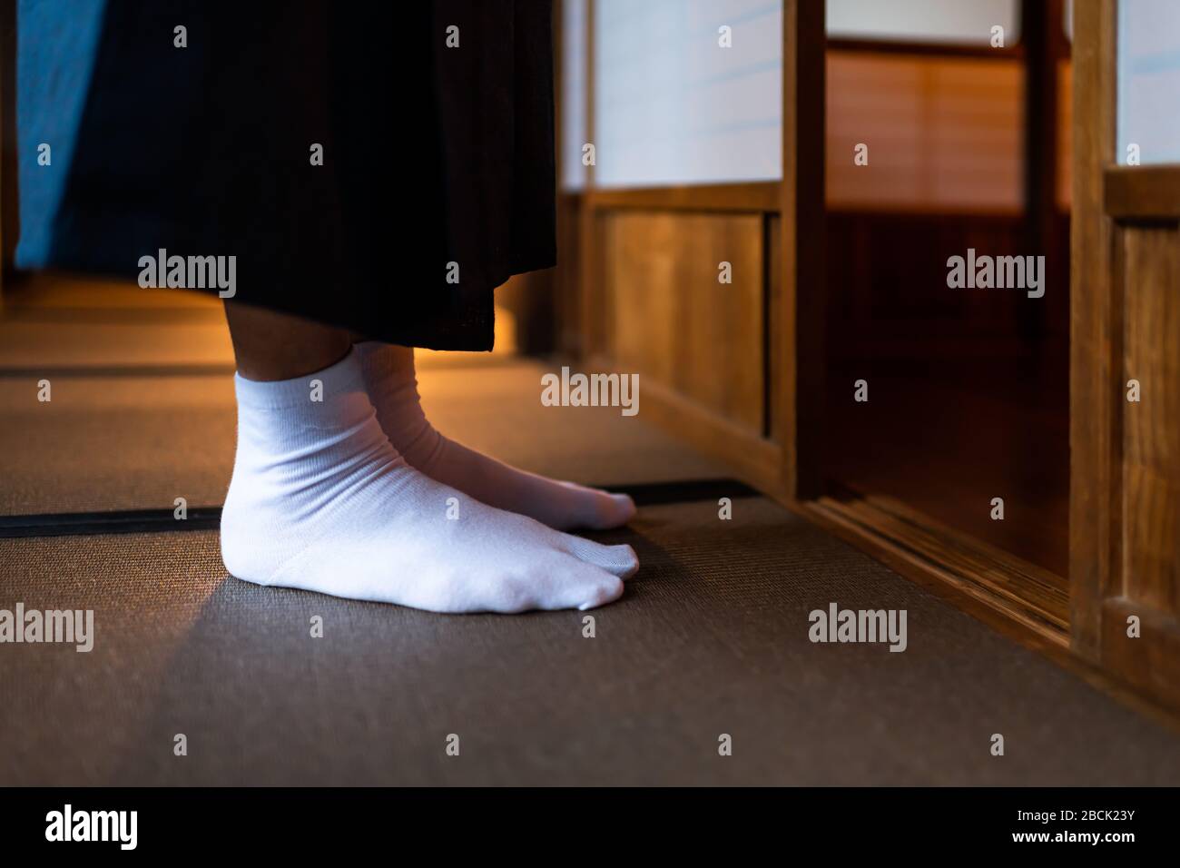 Traditional japanese house or ryokan with man in kimono closeup of legs  feet with tabi white socks by shoji sliding paper doors and tatami mat  floor Stock Photo - Alamy
