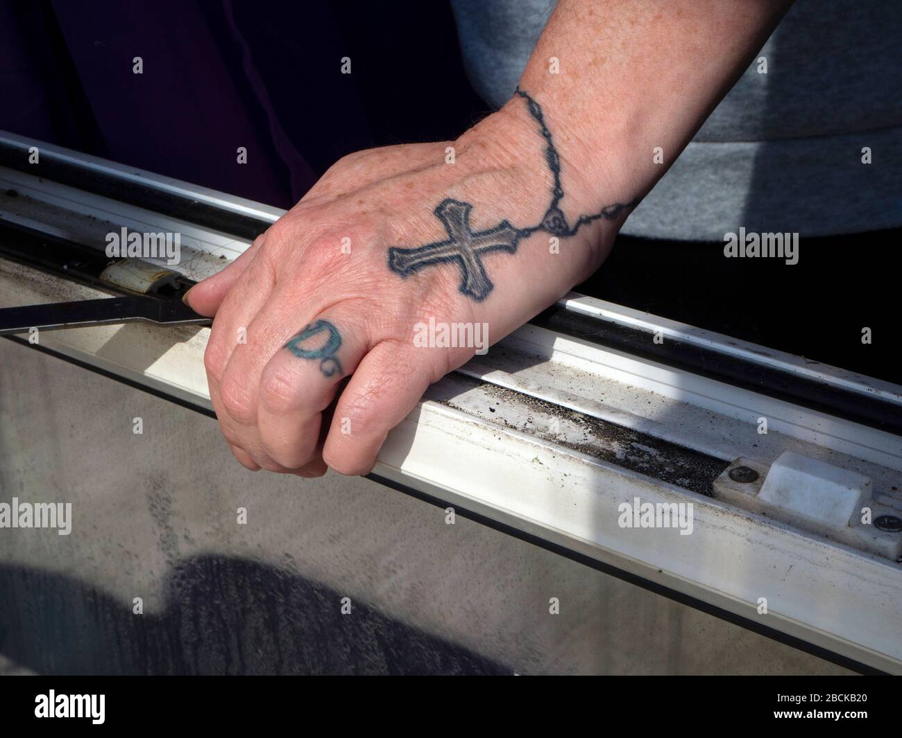 Tattoo of ring, cross and chain around fingers wrist and hand Stock Photo -  Alamy