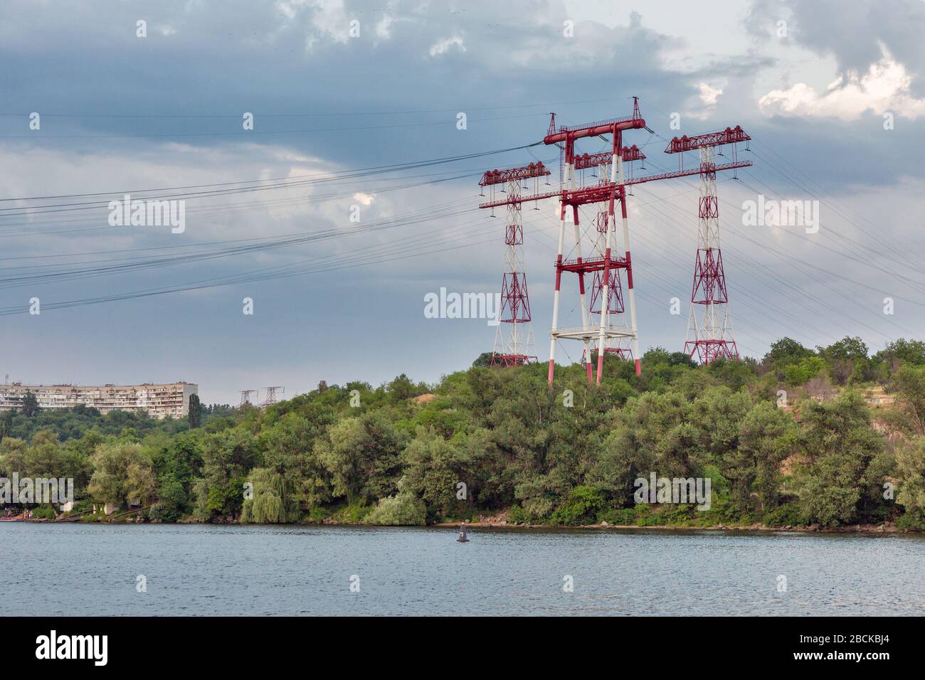 High voltage power lines towers at sunset on island of Khortytsia in Ukraine. Stock Photo