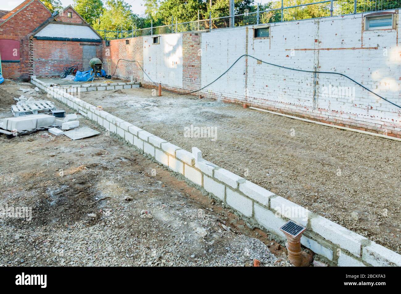Breeze blocks and foundations on a building site, rebuilding and conversion of outbuildings in a UK period house Stock Photo
