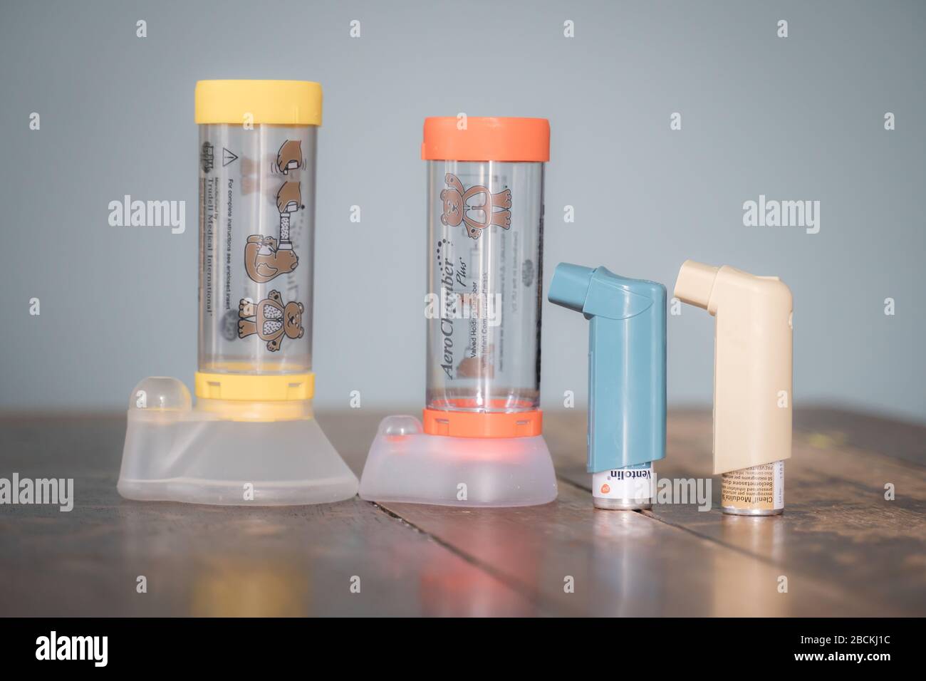 London, UK - April 3, 2020 - Ventolin and Clenil inhalers and Aerochamber spacers (child and infant); common medications for asthma treatment Stock Photo
