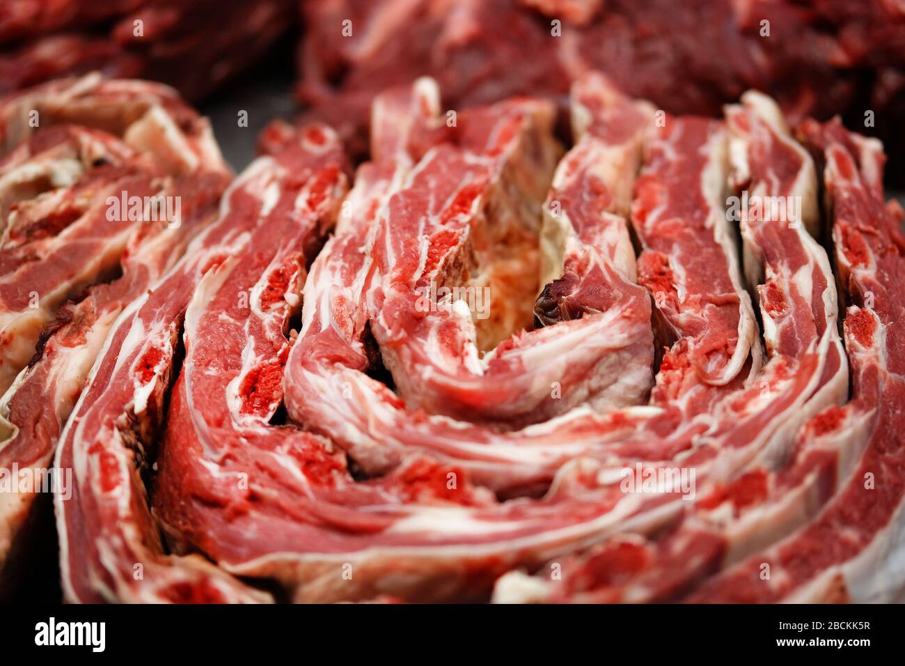 Fresh raw beef ribs on counter of local farmers market. Stock Photo
