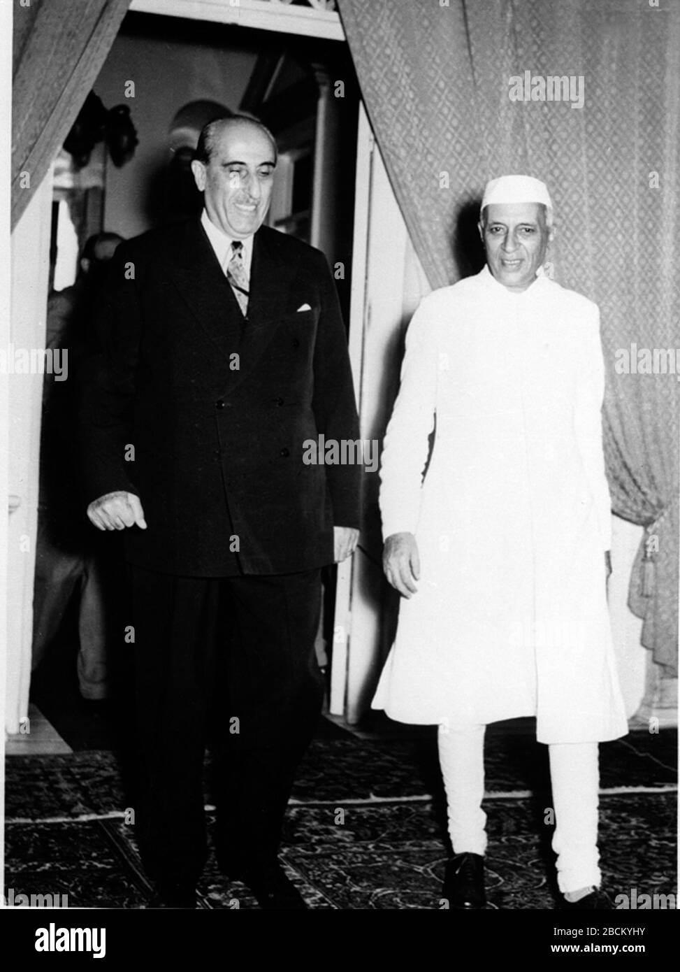 'English: Ph. E.A. Miny./June, 1957, A22a(i)P.M. IN DAMASCUS, JUNE, 1957:President Shukri al-Kuwatly, conducting the Prime Minister, Shri Jawaharlal Nehru, to the Banquet Hall in the Presidential Palace on the occasion of the State Banquet given by the Syrian President Presidential Palace on the occasion of the State Banquet given by the Syrian President in honour of Shri Jawaharlal Nehru during his visit to Syria.; June 1957; http://photodivision.gov.in/writereaddata/webimages/thumbnails/59564.jpg; Photo Division, Ministry of Information & Broadcasting, Government of India; ' Stock Photo