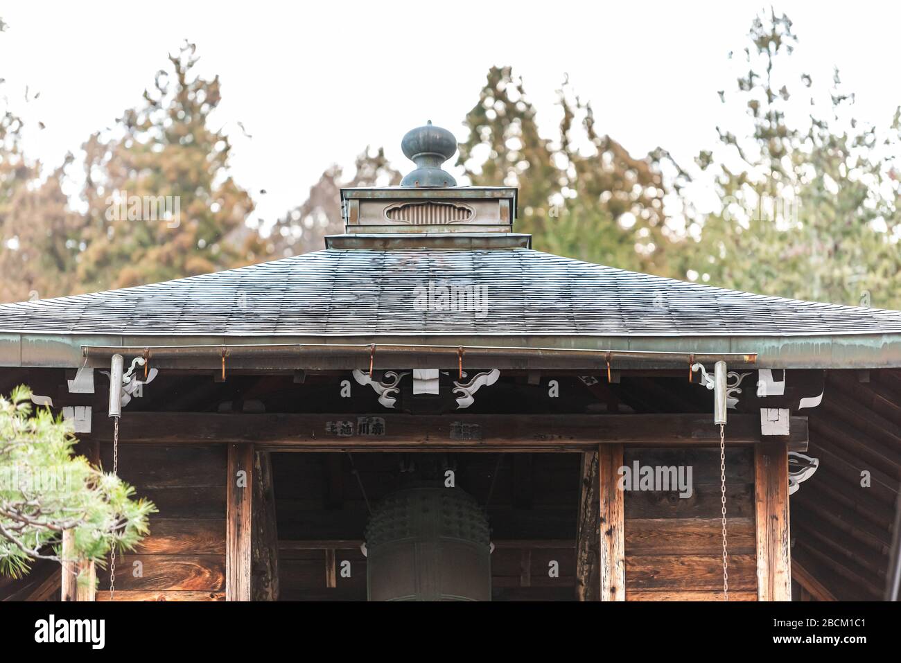 Takayama, Japan - April 9, 2019: Higashiyama walking course for shrines in Gifu Prefecture with closeup of traditional Japanese wooden bell tower tori Stock Photo