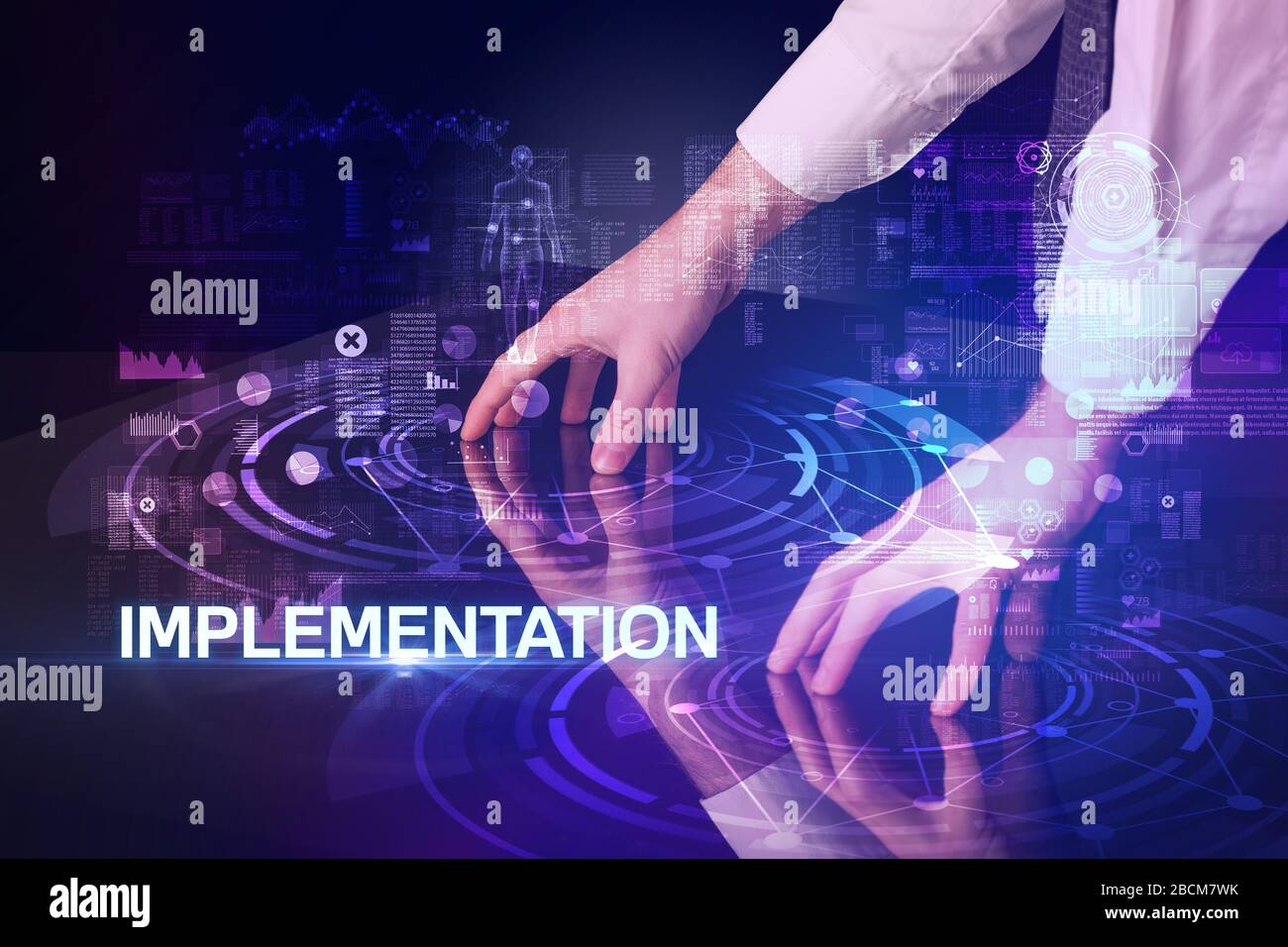 Inscription Technology Businessman touching huge display with IMPLEMENTATION inscription ...