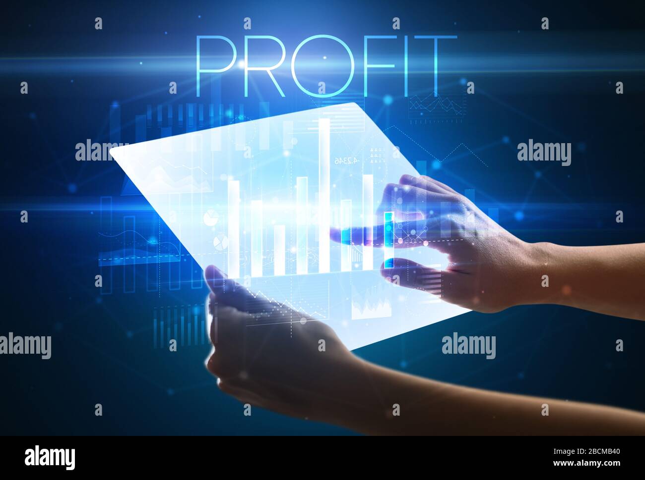 Hand holding futuristic tablet with PROFIT inscription above, modern ...