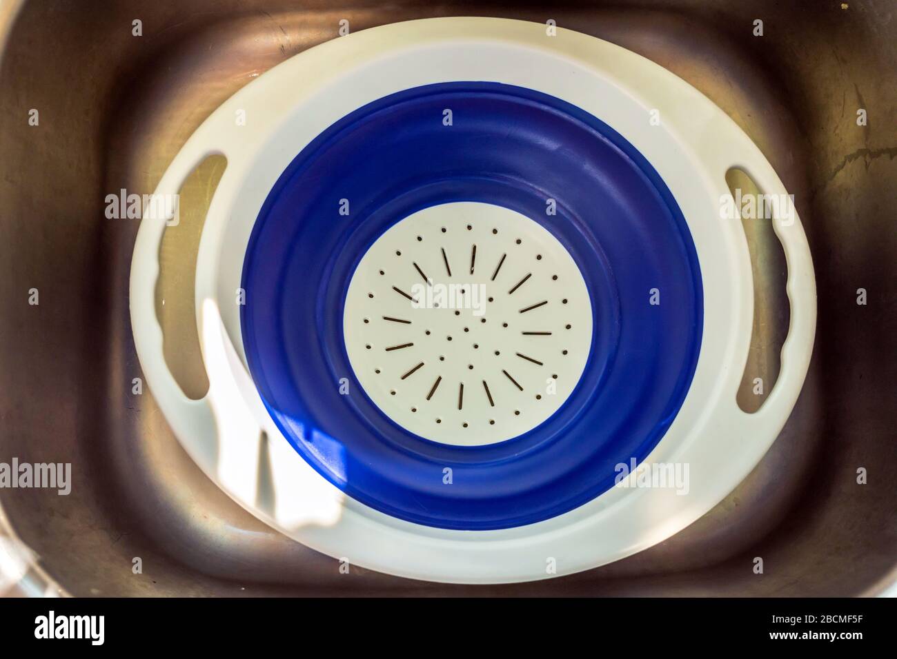 plastic strainer drainer inside kitchen sink prepared for hot food Stock Photo Alamy