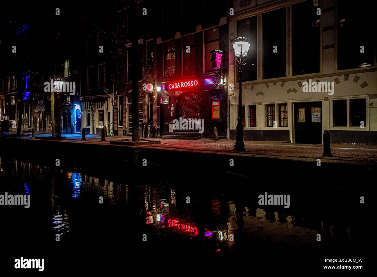 A view of an empty street at the world famous red light district due to the  coronavirus crisis. Normally more than 300 prostitutes offer their services  at the Amsterdamse wallen Stock Photo -