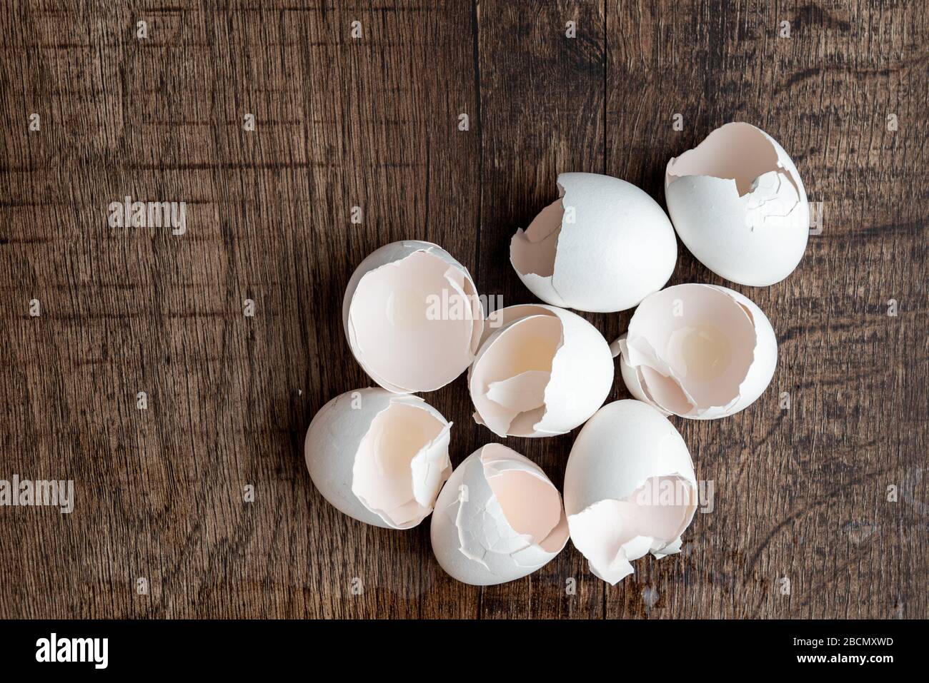 Eight eggshells on a dark wood table Stock Photo