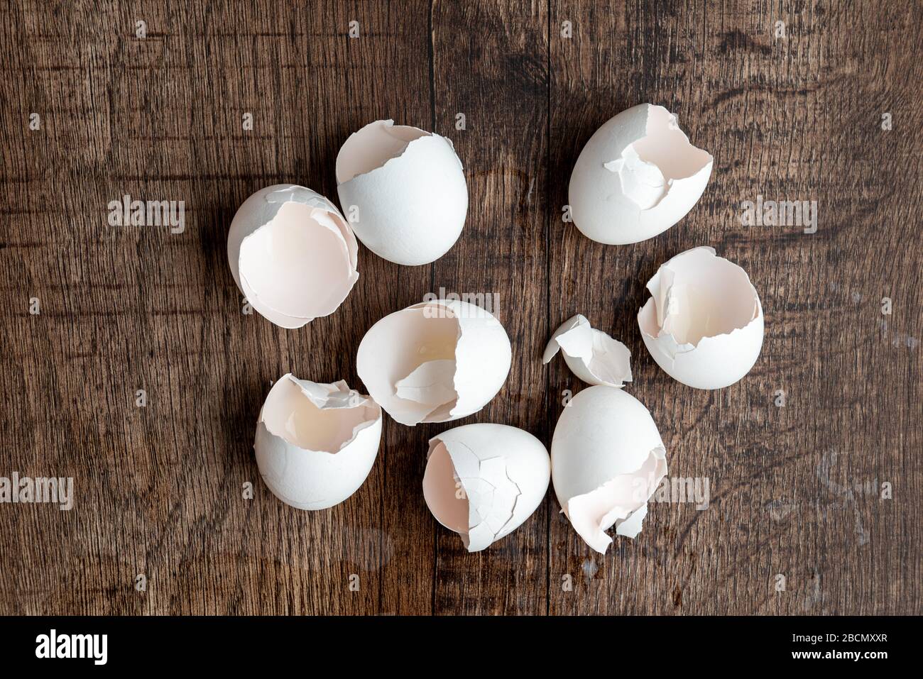 Eight eggshells on a dark wood table Stock Photo