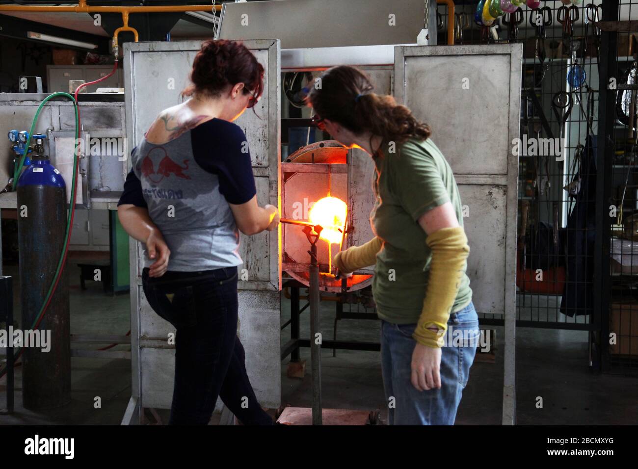 Glass Blowing Workshop - Two Women Shaping glass on the Blowpipe Stock  Photo - Alamy