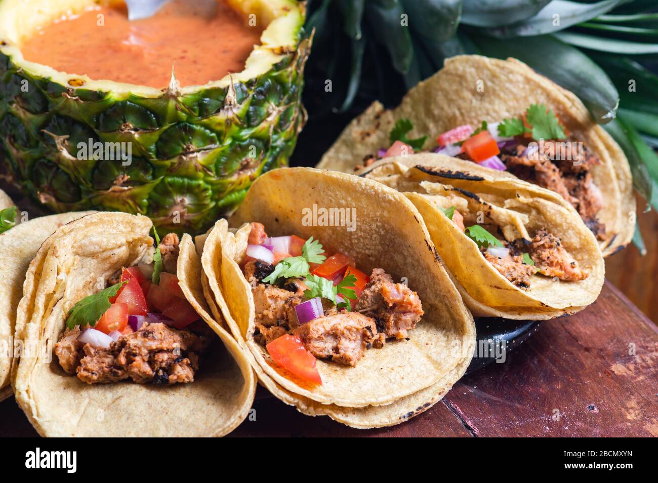 Tacos Al Pastor Shepherd's tacos, known as adobada tacos in the north of Mexico, spiced pork tacos with pineapple and spicy salsa Stock Photo