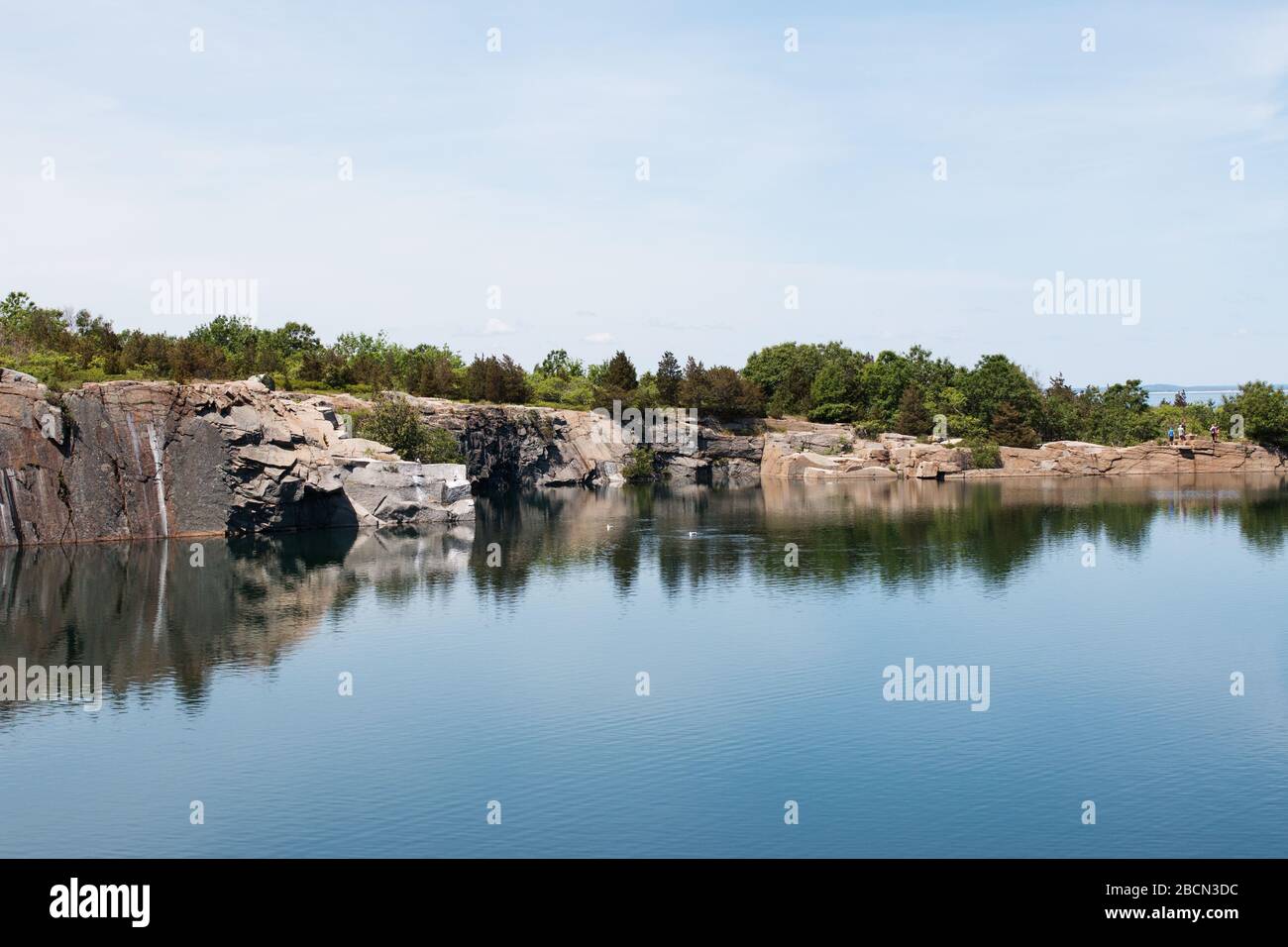 The former Babson Farm granite quarry filled with water at Halibut Point State Park in Rockport, Massachusetts, USA. Stock Photo