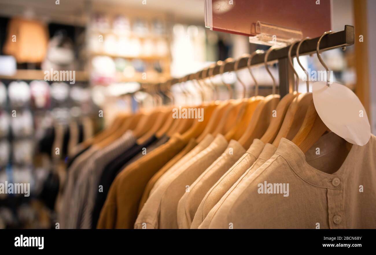 Modern fashion women clothes hang on stanless steel hangers rack at clothing store department store. Casual clothes online shopping Stock Photo Alamy