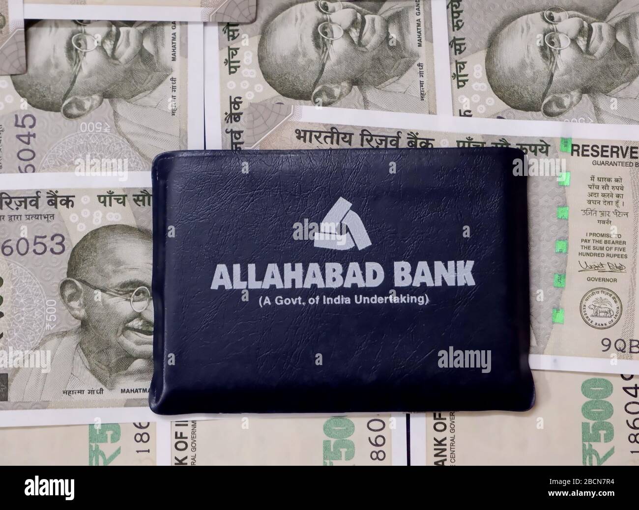 In this photo illustration an Allahabad Bank logo seen with Five hundred Rupee notes on the background. Stock Photo