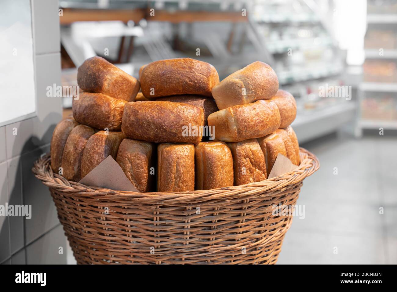 bread rolls in a wicker basket, a bakery in a supermarket Stock Photo