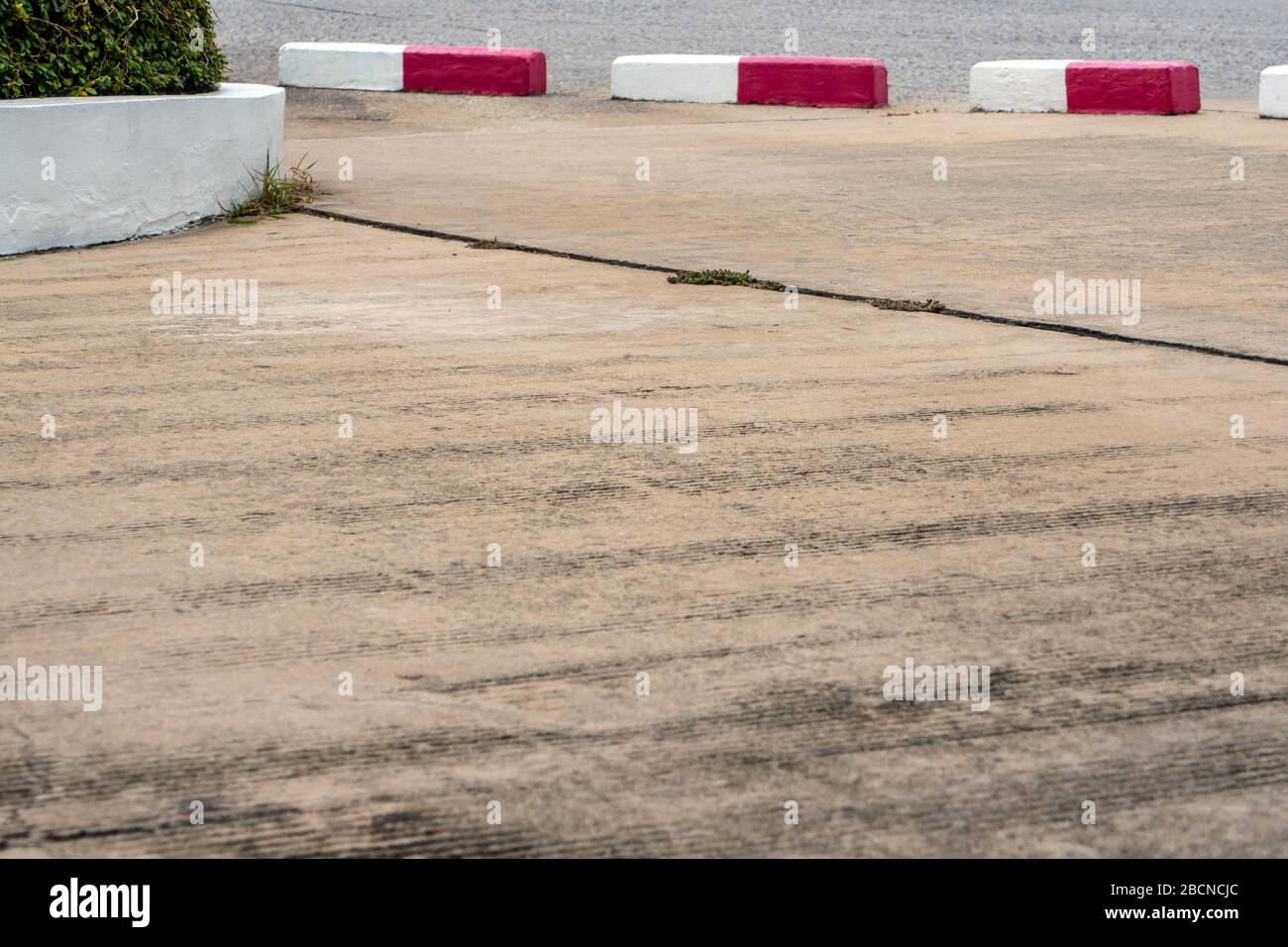 White and red barrier between the road and concrete pavement Stock ...