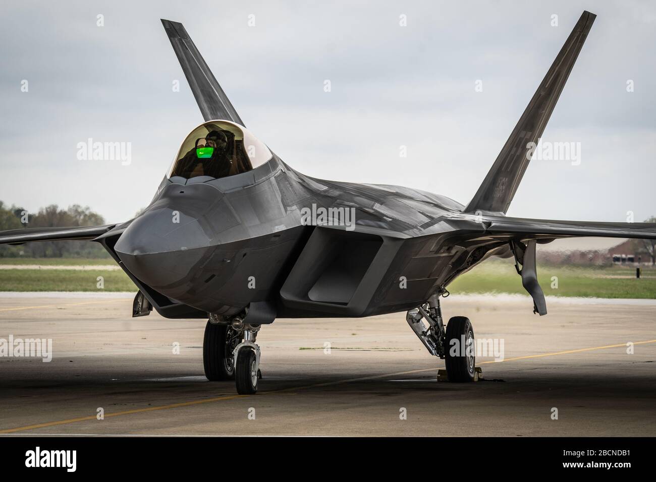 U.S. Air Force Maj. Josh Gunderson, F-22 Raptor Demonstration Team commander and pilot, taxis out before an aerial demonstration at Joint Base Langley-Eustis, Va., March 30, 2020. Maj. Gunderson has over 1,500 hours flying both the F-15 Eagle and F-22 Raptor and is in his first year as commander of the F-22 Raptor Demo Team. (U.S. Air Force photo by Lt. Sam Eckholm) Stock Photo