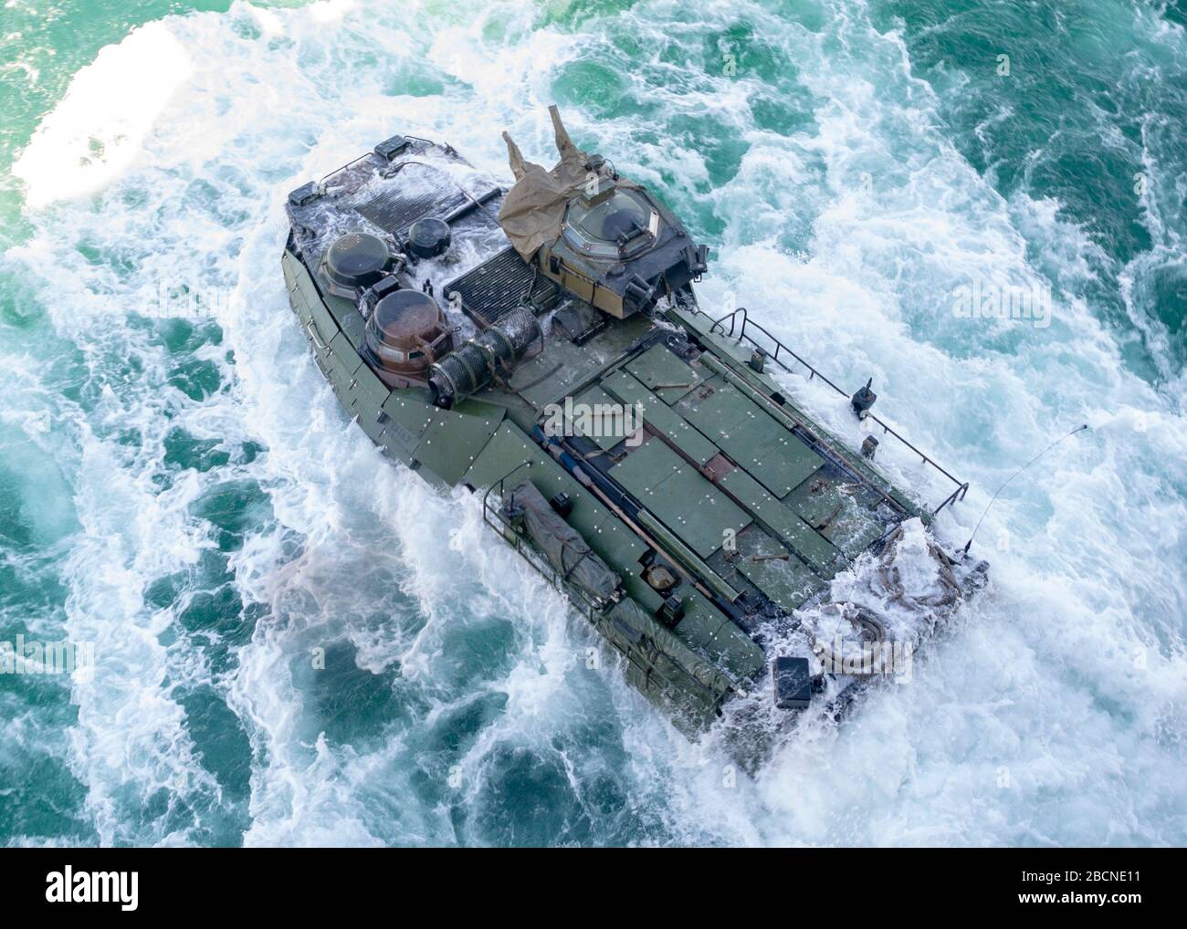 ONSLOW BAY, N.C. (March 18, 2020) – An Amphibious Assault Vehicle (AAV) assigned to 2nd Assault Amphibian Battalion (2nd AABN), 2nd Marine Division based out of Camp Lejeune, N.C. launches off the well deck onboard the Wasp-class amphibious assault ship USS Iwo Jima (LHD 7), March 18, 2020. Iwo Jima and the 2nd AABN are conducting amphibious assault operations certification in the Atlantic Ocean. (U.S. Navy photo by Mass Communications Specialist 3rd Class Jessica Kibena/Released) Stock Photo