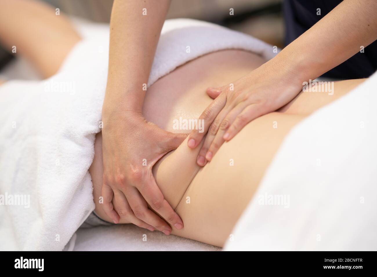 Young woman receiving a back massage in a physiotherapy center Stock Photo