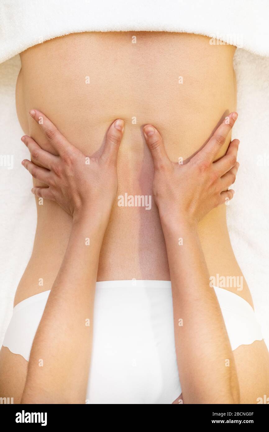 Young woman receiving a back massage in a spa center Stock Photo