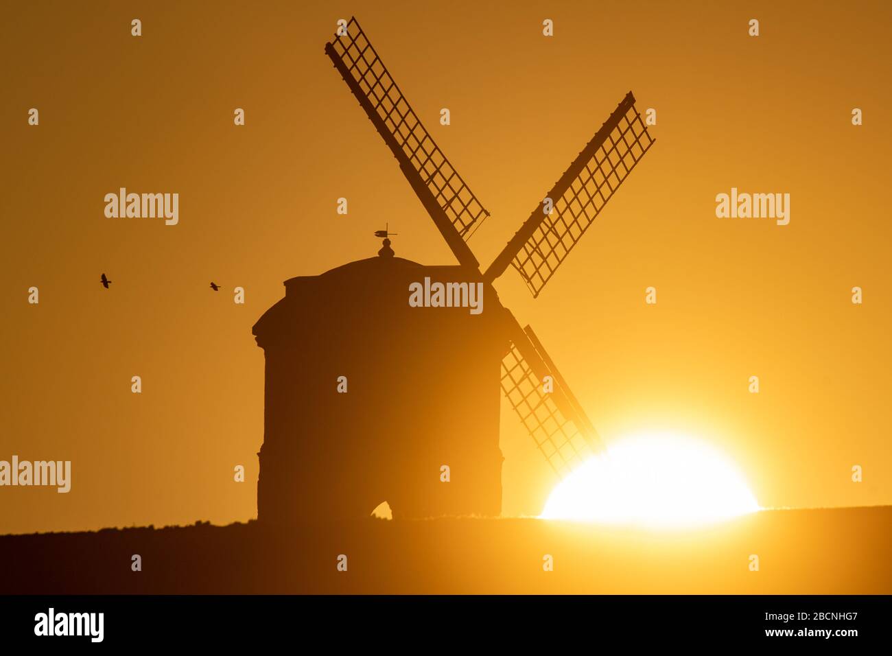 The sun rises over Chesterton Windmill in Warwickshire. Stock Photo