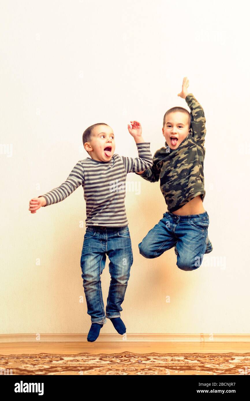 Two boys are playing in the house. children brothers playing together ...