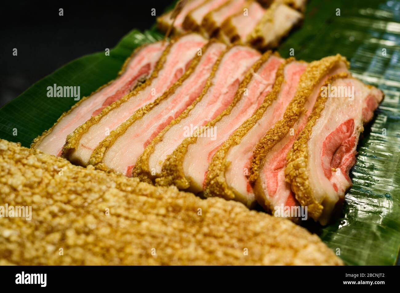 Slices of a fresh meat breading. Thai street food at outdoor night market in Thailand. Stock Photo