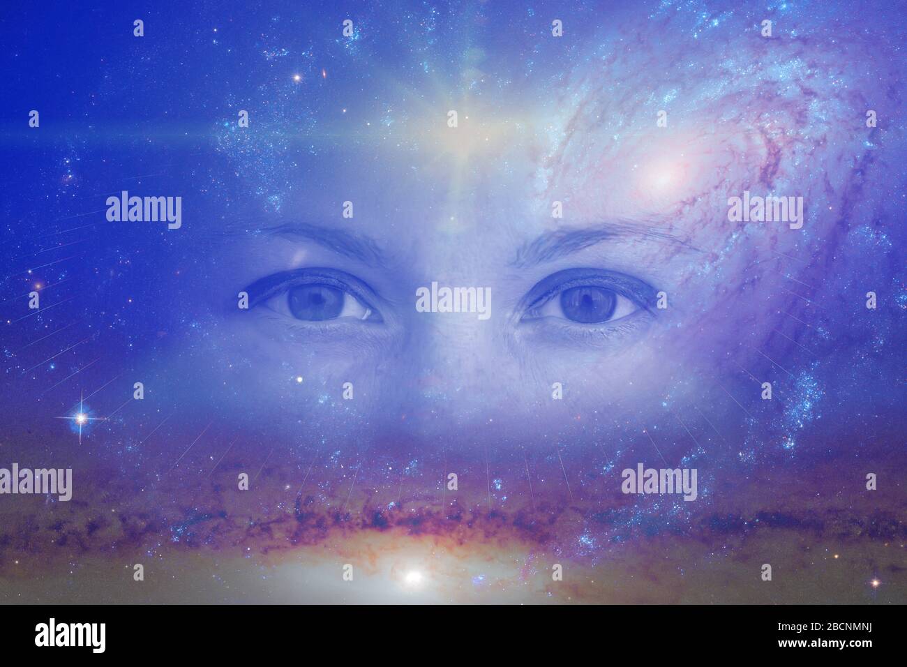 the eyes of a clairvoyant in space against the background of the starry sky and galaxies. The concept of clairvoyance, esotericism or astrology Stock Photo