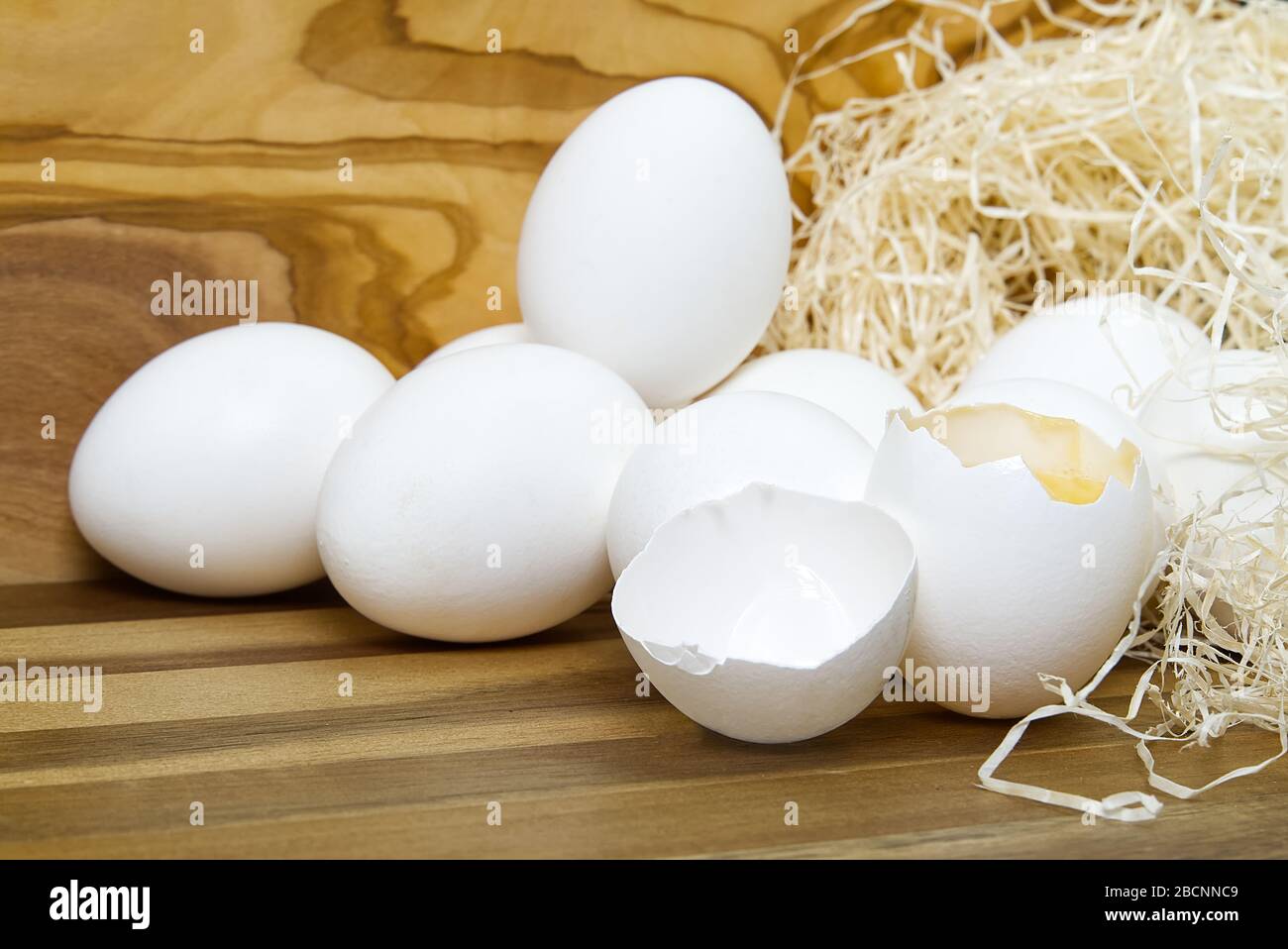 White chicken eggs and broken eggs on wooden board or table Stock Photo ...